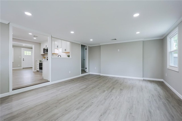 31 Forbes St, East Providence, RI 02915 - unfurnished living room with crown molding, plenty of natural light, recessed lighting, light wood-style floors, and baseboards