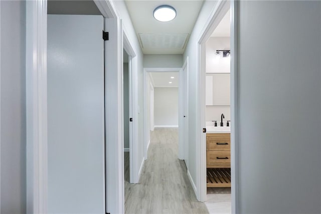 31 Forbes St, East Providence, RI 02915 - hallway featuring light wood finished floors, baseboards, and a sink