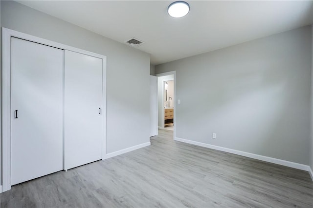 31 Forbes St, East Providence, RI 02915 - unfurnished bedroom featuring wood finished floors, baseboards, and a closet