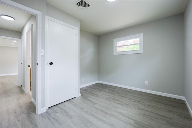 31 Forbes St, East Providence, RI 02915 - unfurnished bedroom with wood finished floors, baseboards, and a closet
