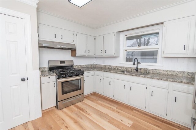 70 Enfield Ave, Providence, RI 02908 - kitchen with gas range, under cabinet range hood, a sink, light wood-style floors, and white cabinetry