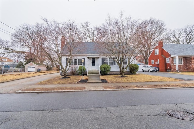 70 Enfield Ave, Providence, RI 02908 - view of front facade with driveway and a chimney