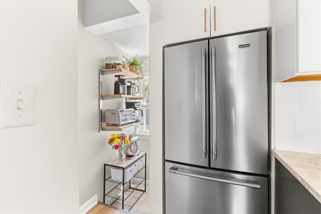 22 Dunedin St, Cranston, RI 02920 - kitchen with high end fridge, open shelves, light stone countertops, and baseboards
