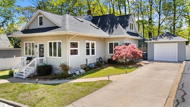 22 Dunedin St, Cranston, RI 02920 - view of front of property featuring roof with shingles, an outbuilding, a detached garage, a chimney, and concrete driveway
