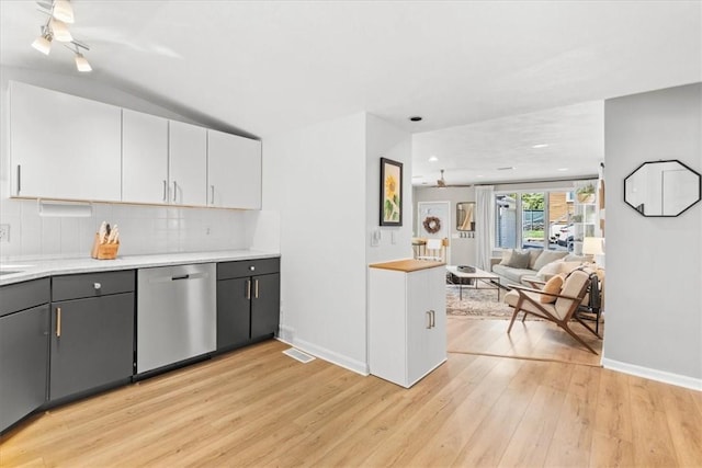 22 Dunedin St, Cranston, RI 02920 - kitchen with stainless steel dishwasher, open floor plan, light wood-style flooring, backsplash, and light countertops