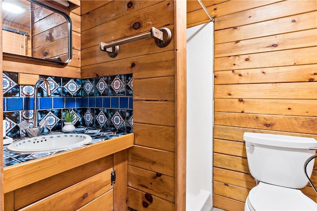 310 Old Coach Rd, Charlestown, RI 02813 - bathroom featuring decorative backsplash, toilet, vanity, and wooden walls