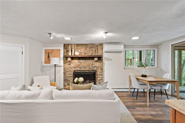310 Old Coach Rd, Charlestown, RI 02813 - living room with an AC wall unit, dark wood-style flooring, a fireplace, baseboard heating, and baseboards