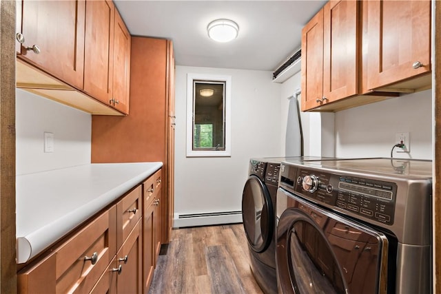 310 Old Coach Rd, Charlestown, RI 02813 - laundry room featuring a baseboard radiator, wood finished floors, washer and dryer, and cabinet space