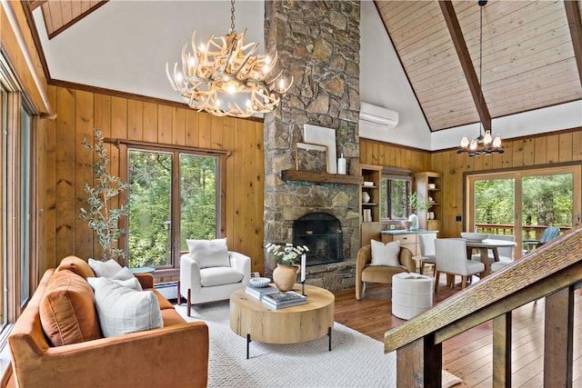 310 Old Coach Rd, Charlestown, RI 02813 - living room with a chandelier, high vaulted ceiling, wooden walls, a wall unit AC, and plenty of natural light