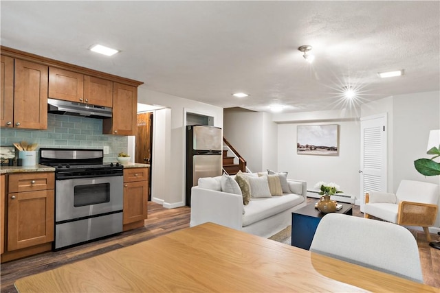 310 Old Coach Rd, Charlestown, RI 02813 - kitchen featuring stainless steel appliances, under cabinet range hood, brown cabinetry, and a baseboard radiator