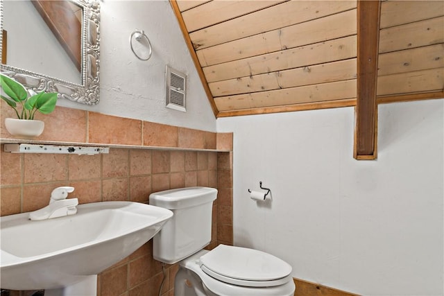 310 Old Coach Rd, Charlestown, RI 02813 - bathroom with a sink, toilet, tile walls, and lofted ceiling