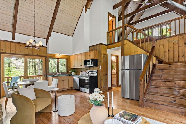 310 Old Coach Rd, Charlestown, RI 02813 - living area with high vaulted ceiling, a chandelier, light wood-style floors, wood ceiling with exposed beams, and stairway
