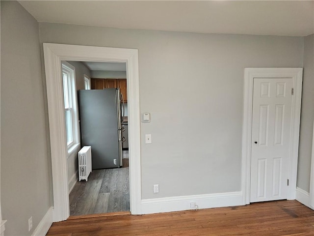 29 Arthur St, Warwick, RI 02888 - spare room featuring radiator, wood finished floors, and baseboards