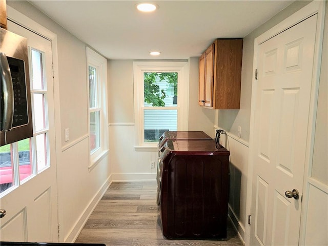 29 Arthur St, Warwick, RI 02888 - washroom featuring cabinet space, light wood-type flooring, washer and clothes dryer, baseboards, and recessed lighting
