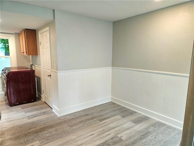 29 Arthur St, Warwick, RI 02888 - unfurnished dining area with light wood finished floors, wainscoting, and baseboards