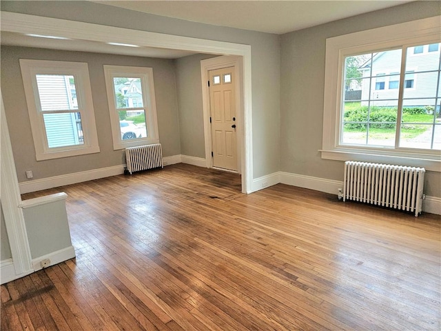 29 Arthur St, Warwick, RI 02888 - entryway with radiator heating unit, wood-type flooring, and baseboards