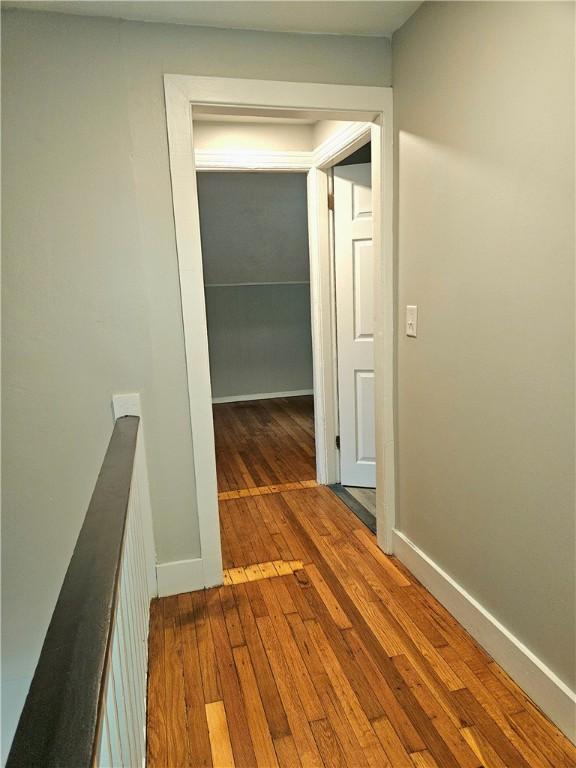 29 Arthur St, Warwick, RI 02888 - corridor with an upstairs landing, hardwood / wood-style flooring, and baseboards