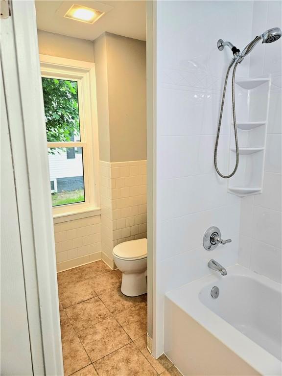 29 Arthur St, Warwick, RI 02888 - full bath with toilet, tile patterned floors, tile walls, bathtub / shower combination, and a wainscoted wall