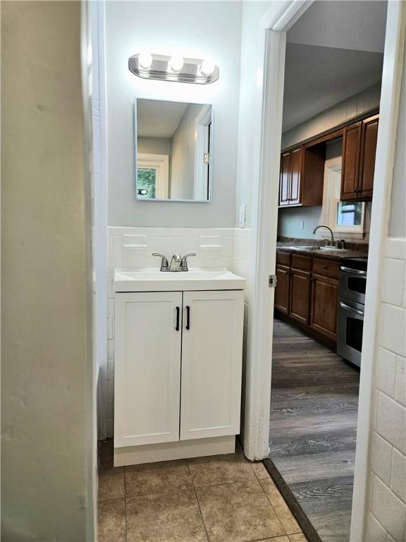 29 Arthur St, Warwick, RI 02888 - bathroom with vanity, tile patterned floors, and a wainscoted wall