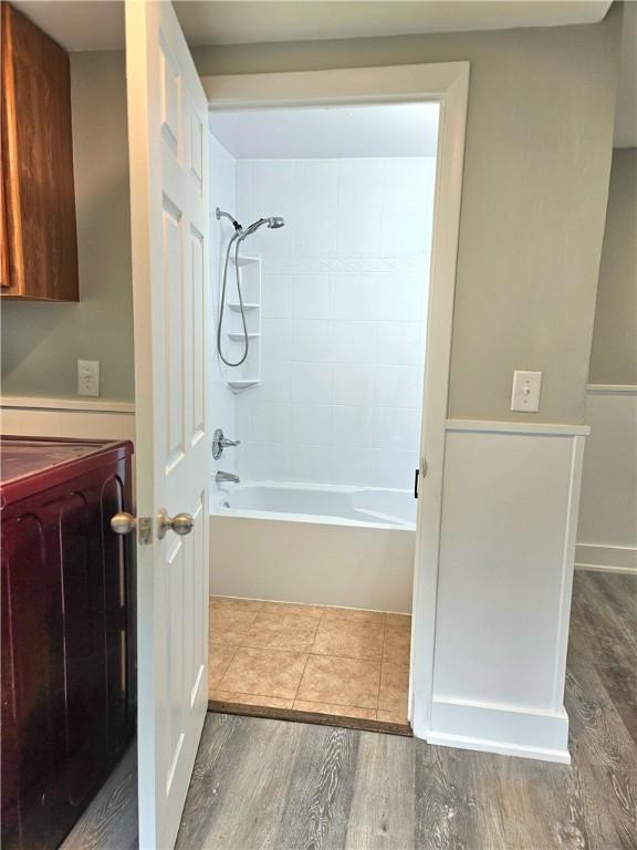 29 Arthur St, Warwick, RI 02888 - full bathroom with wood finished floors, washer / clothes dryer, and bathing tub / shower combination