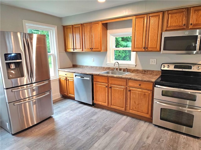 29 Arthur St, Warwick, RI 02888 - kitchen featuring stainless steel appliances, a sink, and brown cabinets