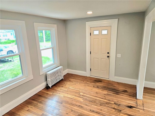 29 Arthur St, Warwick, RI 02888 - entrance foyer with radiator, light wood-type flooring, baseboards, and recessed lighting
