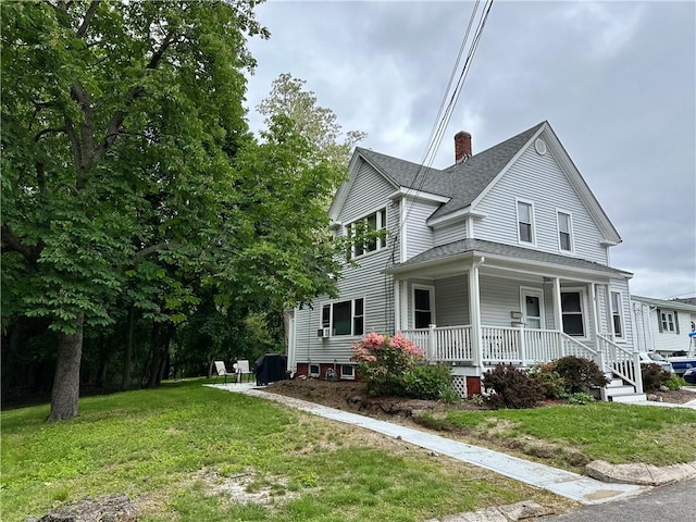 3 Jefferson St, Warwick, RI 02888 - view of front of home with a porch, a chimney, a front lawn, and roof with shingles