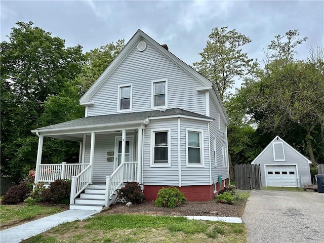 3 Jefferson St, Warwick, RI 02888 - view of front facade featuring a porch, a detached garage, asphalt driveway, and an outbuilding