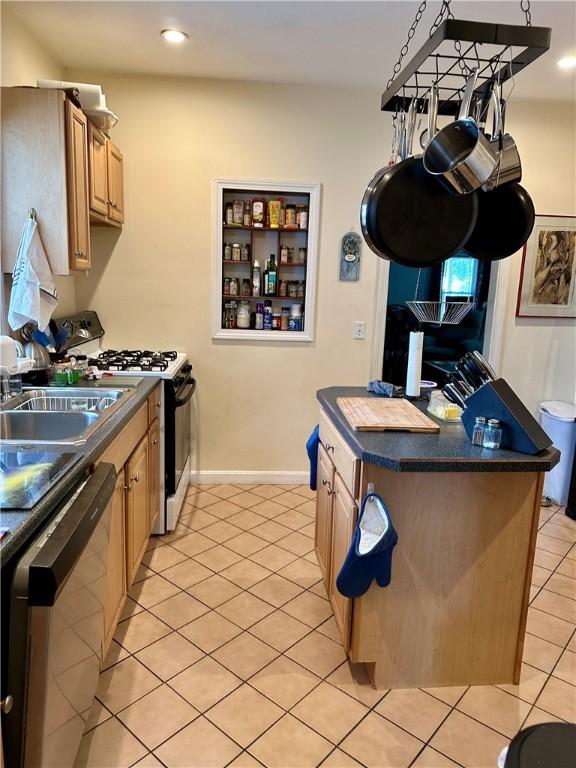 3 Jefferson St, Warwick, RI 02888 - kitchen with range with gas stovetop, dark countertops, dishwasher, light tile patterned flooring, and light brown cabinetry