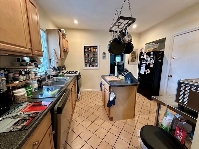 3 Jefferson St, Warwick, RI 02888 - kitchen featuring freestanding refrigerator, range with gas stovetop, a sink, dark countertops, and light tile patterned floors
