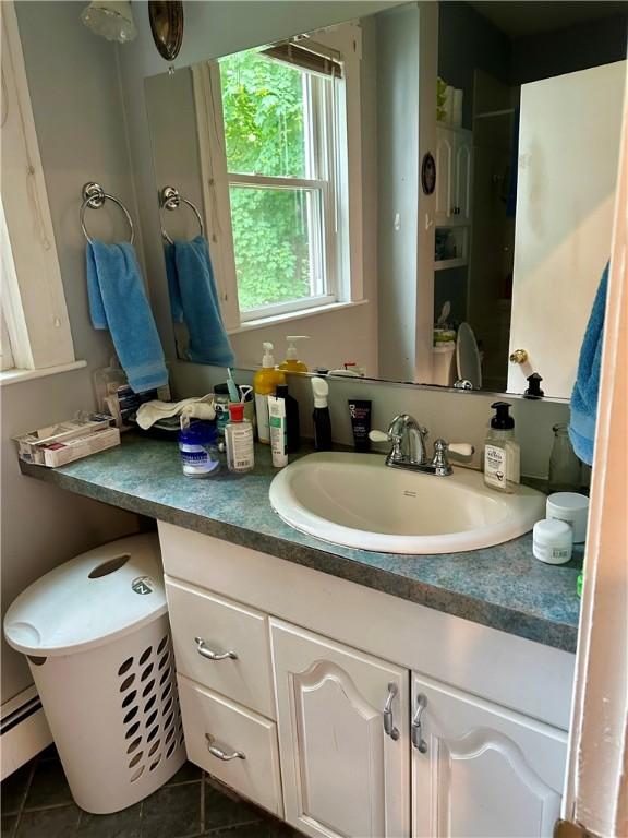 3 Jefferson St, Warwick, RI 02888 - bathroom featuring vanity, tile patterned floors, and a baseboard radiator