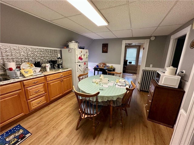 3 Jefferson St, Warwick, RI 02888 - dining room with radiator, a paneled ceiling, light wood finished floors, and a wainscoted wall
