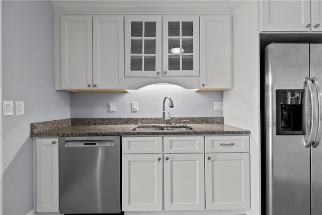 446 Paddock Ln, Bristol, RI 02809 - kitchen featuring appliances with stainless steel finishes, a sink, glass insert cabinets, and dark stone counters