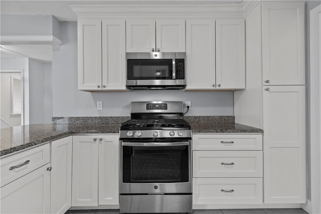 446 Paddock Ln, Bristol, RI 02809 - kitchen featuring stainless steel appliances, dark stone counters, and white cabinets