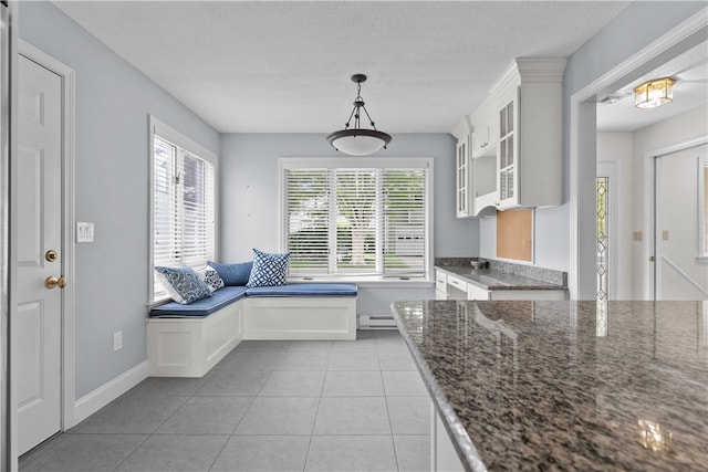 446 Paddock Ln, Bristol, RI 02809 - mudroom with light tile patterned floors, baseboard heating, a textured ceiling, and baseboards