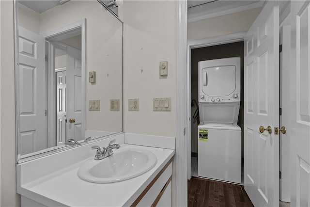 446 Paddock Ln, Bristol, RI 02809 - bathroom featuring stacked washer / dryer, wood finished floors, and vanity