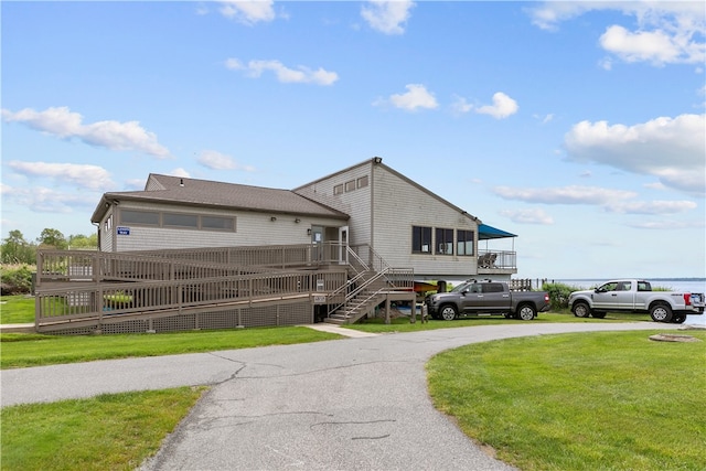 446 Paddock Ln, Bristol, RI 02809 - view of front of house featuring a front yard, stairs, a wooden deck, and driveway
