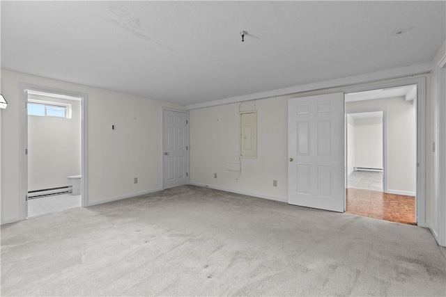 446 Paddock Ln, Bristol, RI 02809 - unfurnished bedroom with a baseboard heating unit, carpet, baseboards, and ensuite bath