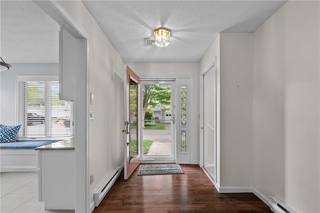 446 Paddock Ln, Bristol, RI 02809 - entryway with a baseboard radiator, healthy amount of natural light, a textured ceiling, and wood finished floors