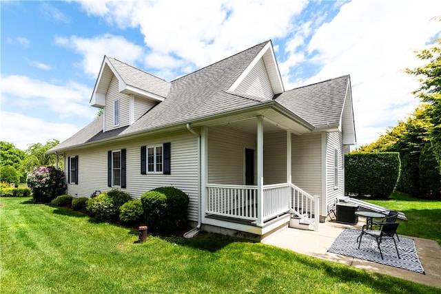 10 Kristin Ct, Coventry, RI 02816 - view of side of property featuring a shingled roof, a lawn, and a patio area