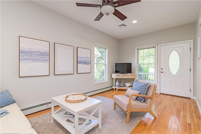 10 Kristin Ct, Coventry, RI 02816 - living room with baseboard heating, ceiling fan, light wood finished floors, and recessed lighting