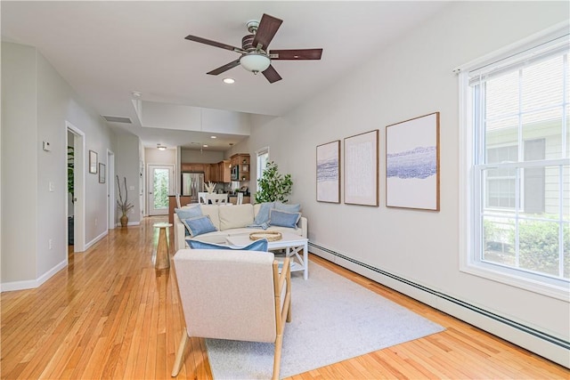 10 Kristin Ct, Coventry, RI 02816 - living room with a baseboard radiator, light wood finished floors, ceiling fan, recessed lighting, and baseboards