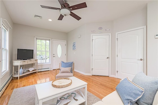 10 Kristin Ct, Coventry, RI 02816 - living room with baseboard heating, a ceiling fan, light wood finished floors, recessed lighting, and baseboards