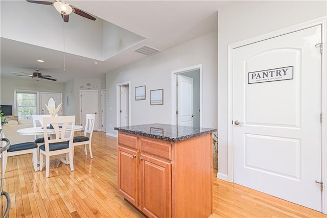10 Kristin Ct, Coventry, RI 02816 - kitchen featuring a ceiling fan, light wood-type flooring, and dark stone countertops