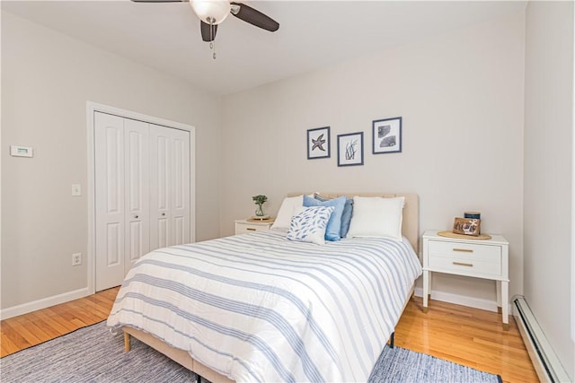 10 Kristin Ct, Coventry, RI 02816 - bedroom featuring a baseboard radiator, light wood-style floors, a closet, baseboards, and a ceiling fan