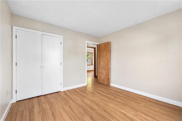 40 Atlantic St, Newport, RI 02840 - unfurnished bedroom with baseboards, light wood-style floors, and a closet