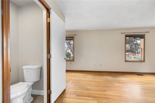 40 Atlantic St, Newport, RI 02840 - bathroom featuring plenty of natural light, wood finished floors, toilet, and baseboards