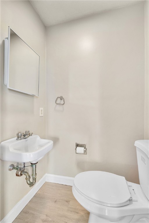 40 Atlantic St, Newport, RI 02840 - half bath with toilet, baseboards, wood finished floors, and a sink