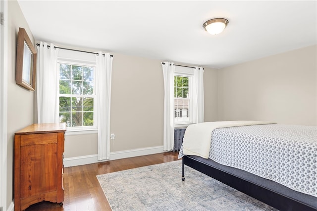 405 Eaton St, Providence, RI 02908 - bedroom with wood finished floors, baseboards, and radiator heating unit