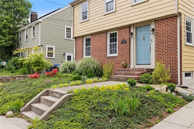 405 Eaton St, Providence, RI 02908 - doorway to property with a chimney and brick siding
